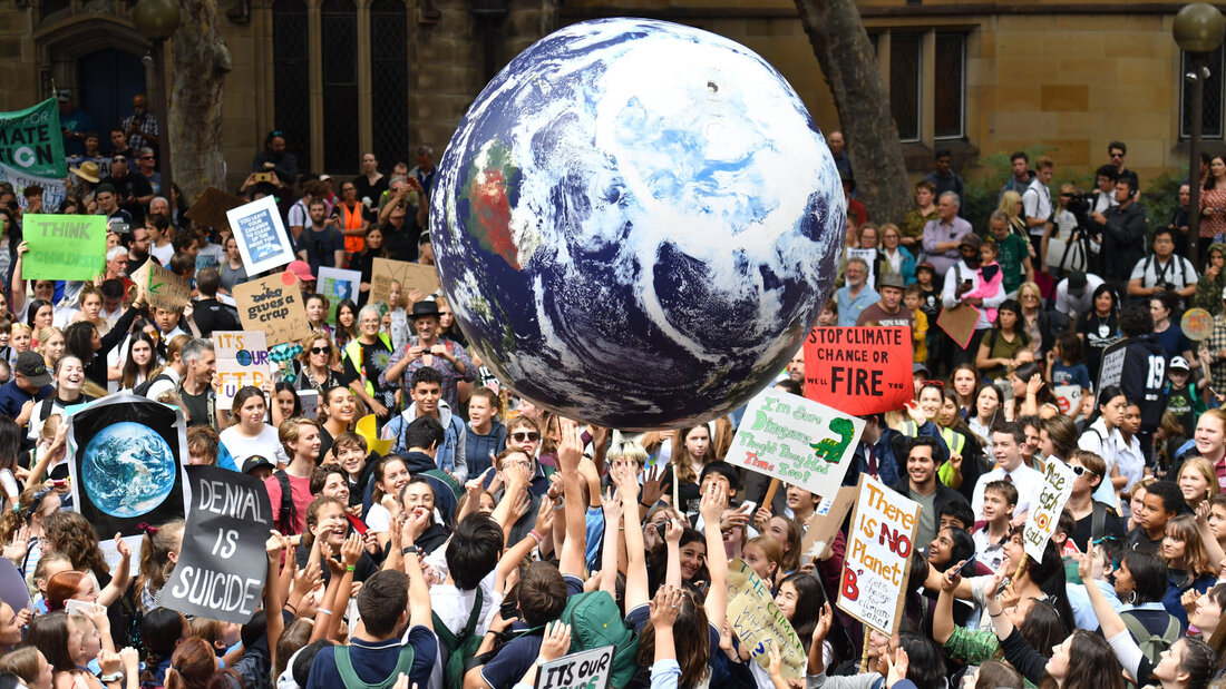 image of climate protest with images of Earth. ecotherapy counselling